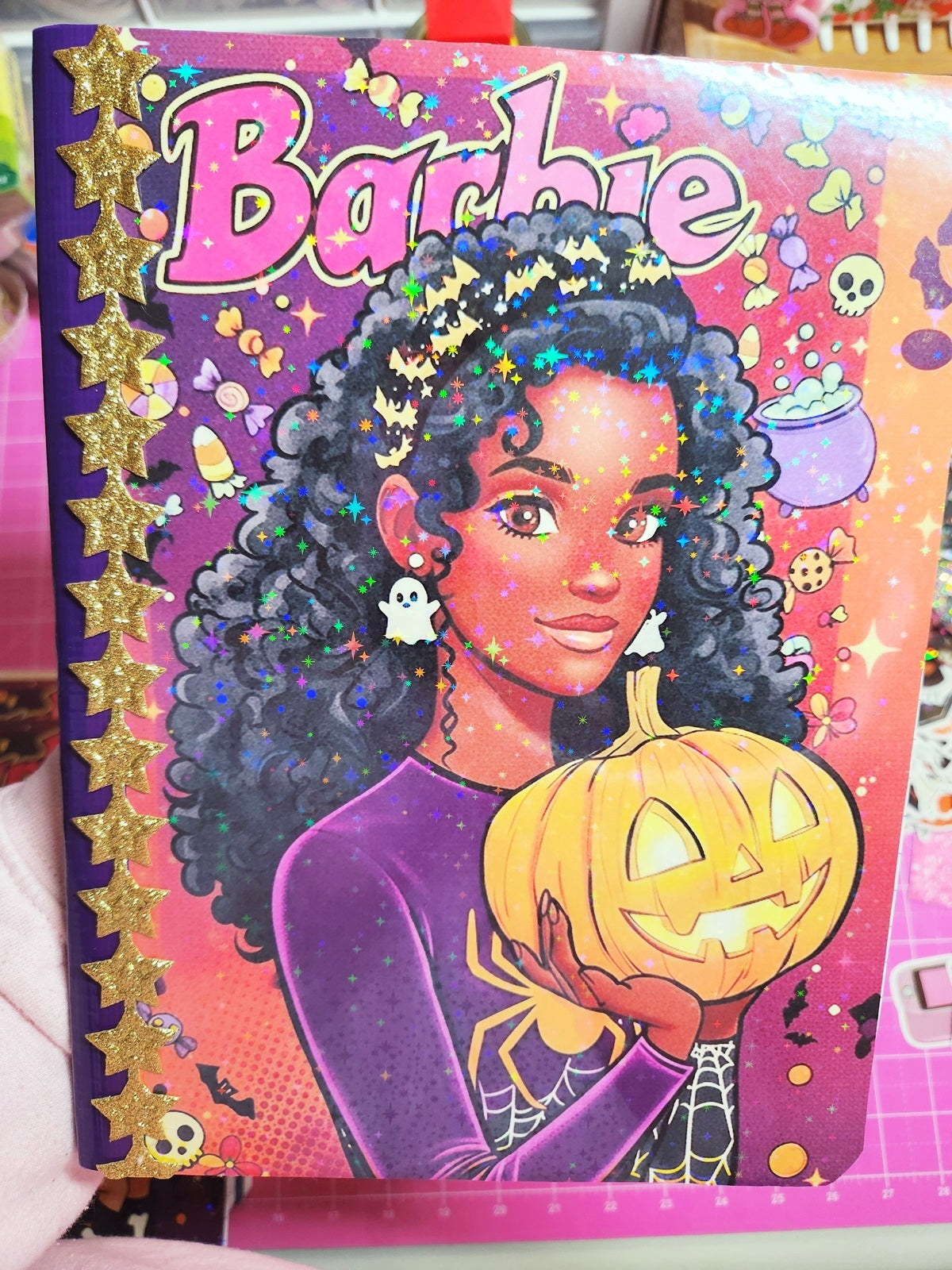 Barbie book cover with a character holding a pumpkin, surrounded by Halloween-themed decorations.