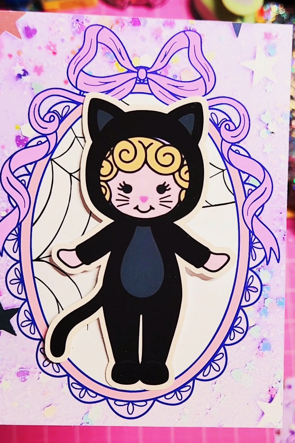 Illustration of a character in a black cat costume with a purple bow on a colorful background