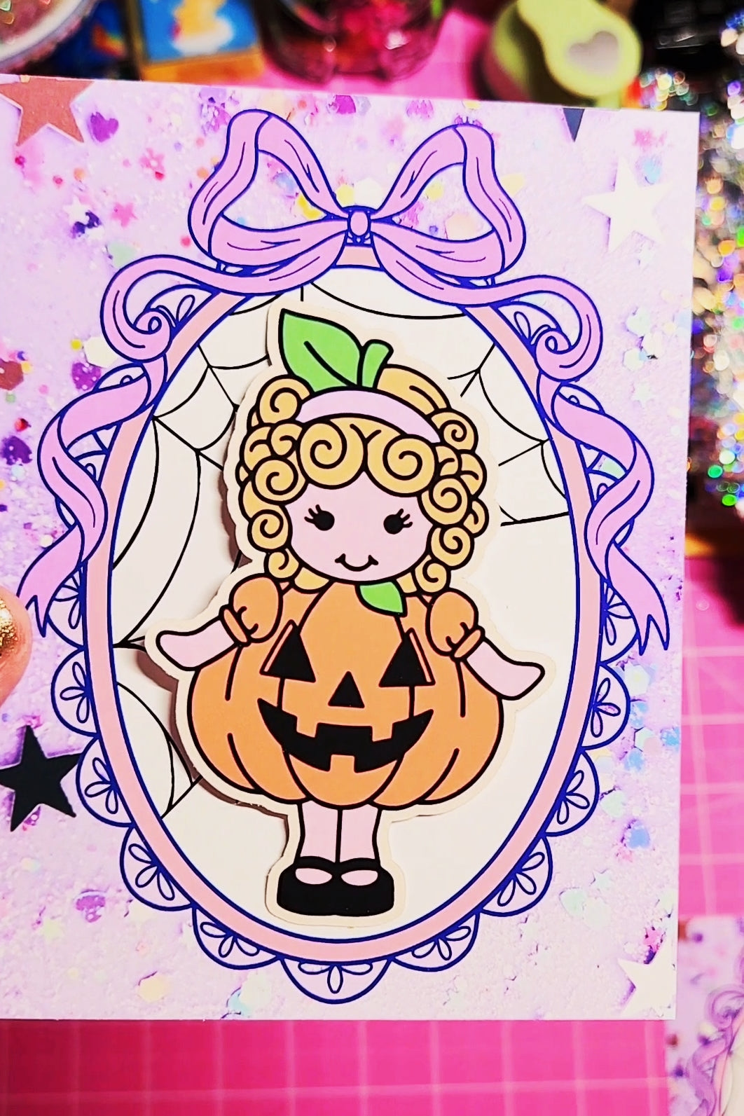 Cartoon character in a pumpkin costume with a purple bow on a colorful background