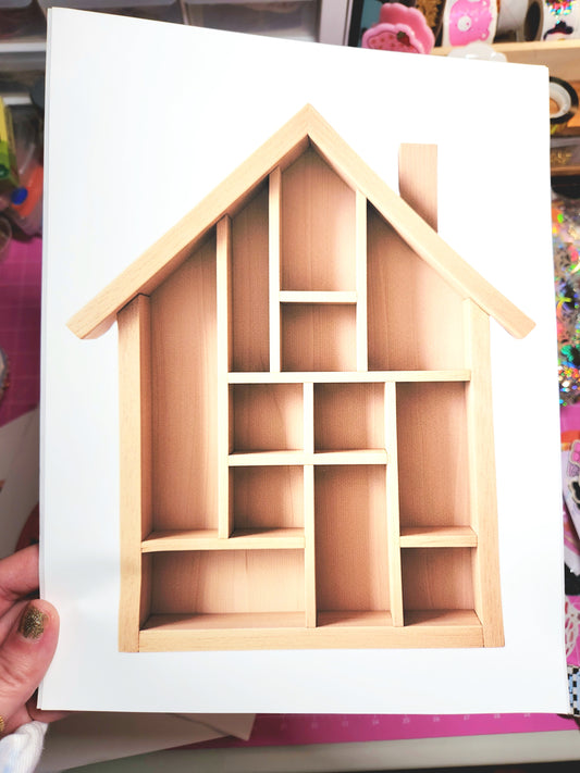 Wooden house-shaped display shelf on a white background