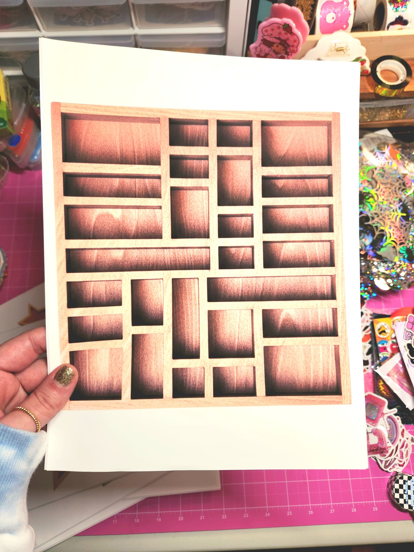 Wooden stamp block with square holes held by a hand on a colorful background