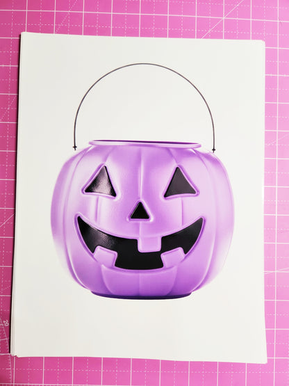 Purple Halloween candy bucket on a pink cutting mat