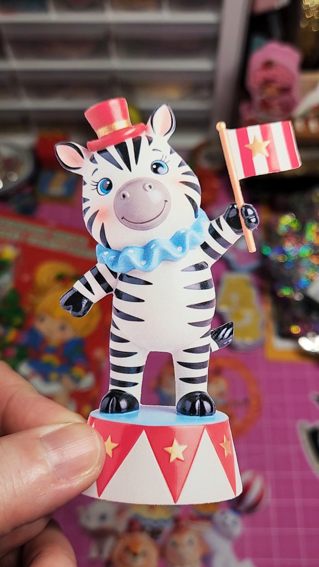 Zebra figurine holding a flag on a colorful background