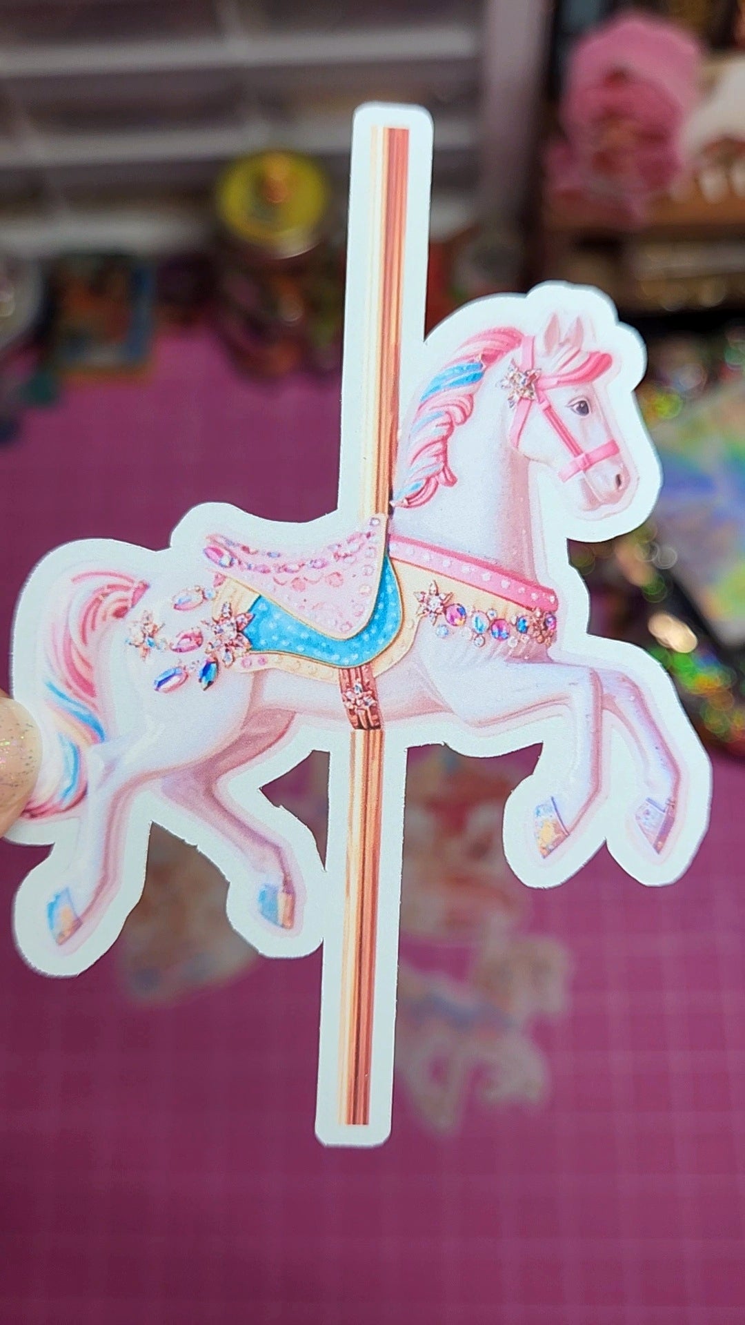 Decorative sticker of a carousel horse on a pink background