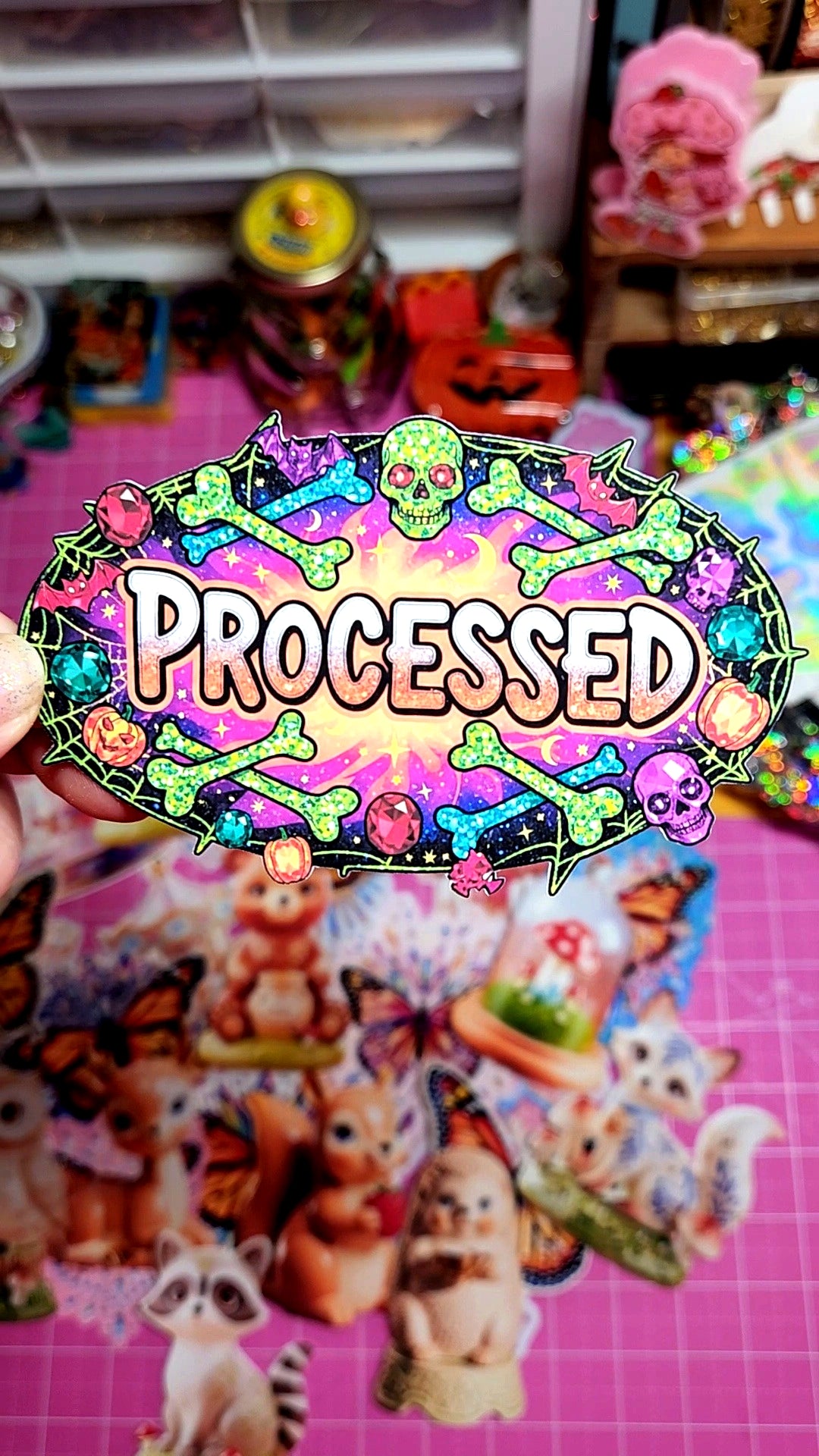 Colorful 'Processed' sticker with cartoon animals on a pink background