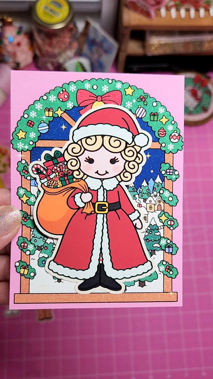 Illustration of a character in a Santa Claus outfit with festive decorations on a pink card.