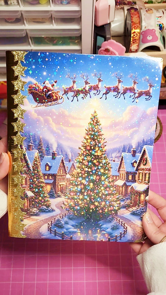 Decorative Christmas card with Santa Claus and reindeer in a snowy village scene.