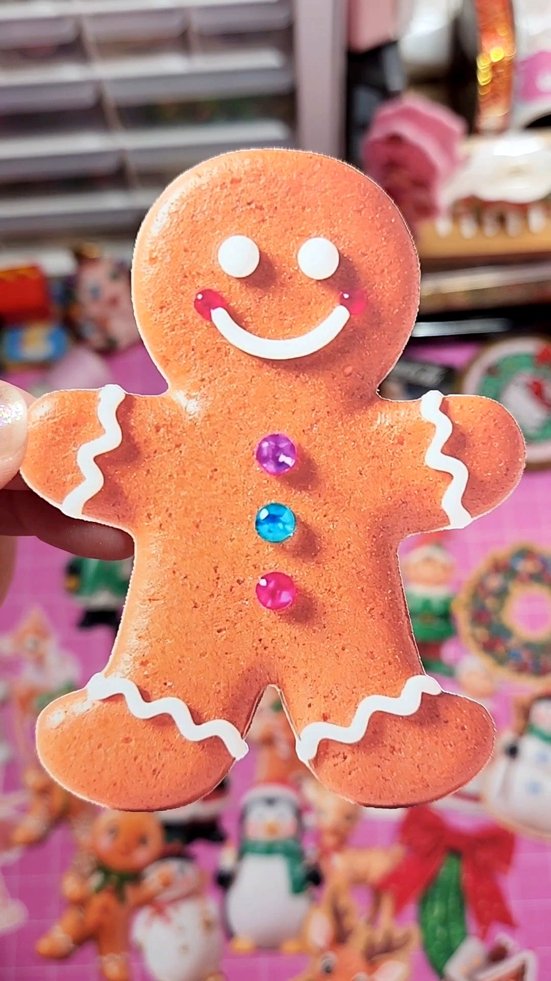 Gingerbread man cookie with colorful buttons against a blurred festive background