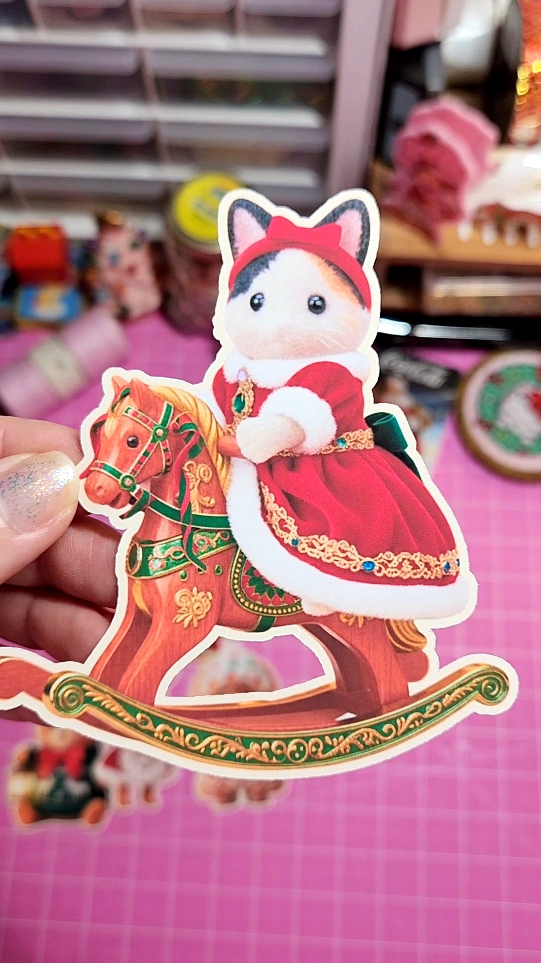 Sticker of a cat character on a rocking horse with a blurred background