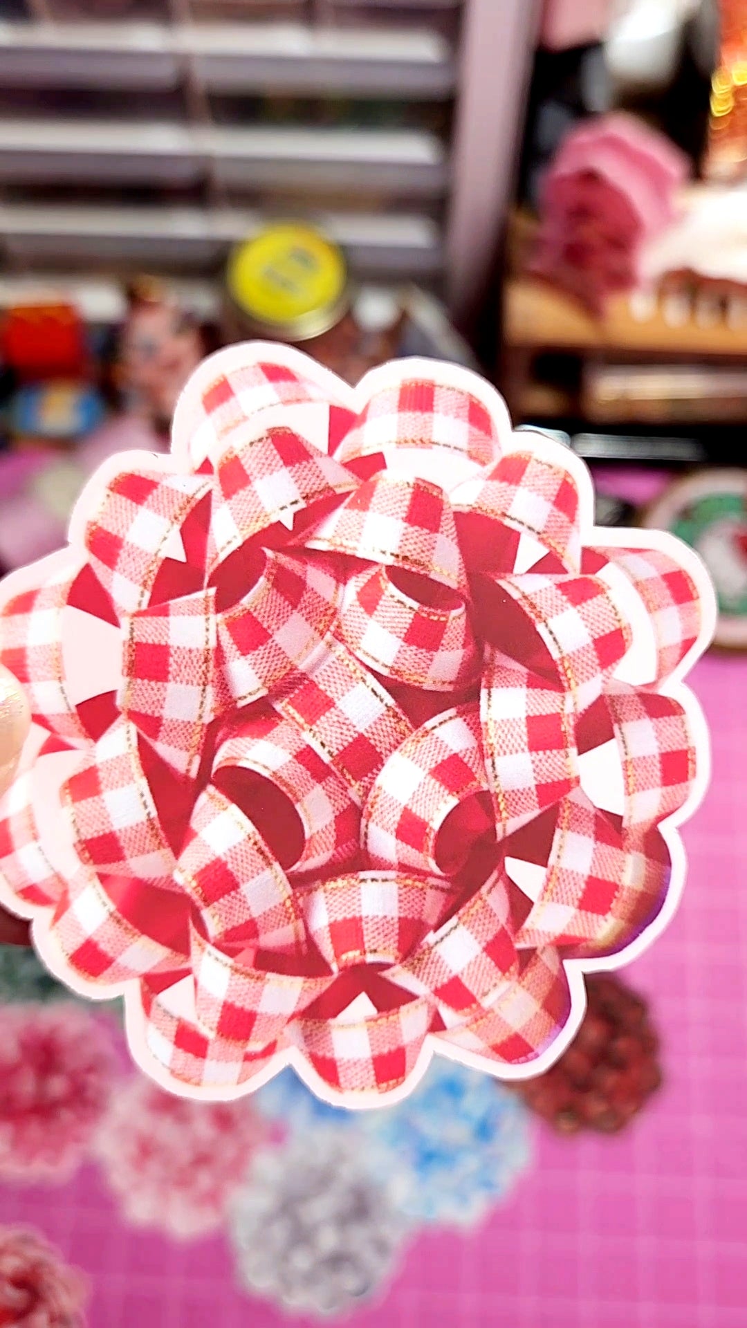 Red and white checkered flower-shaped object on a blurred background