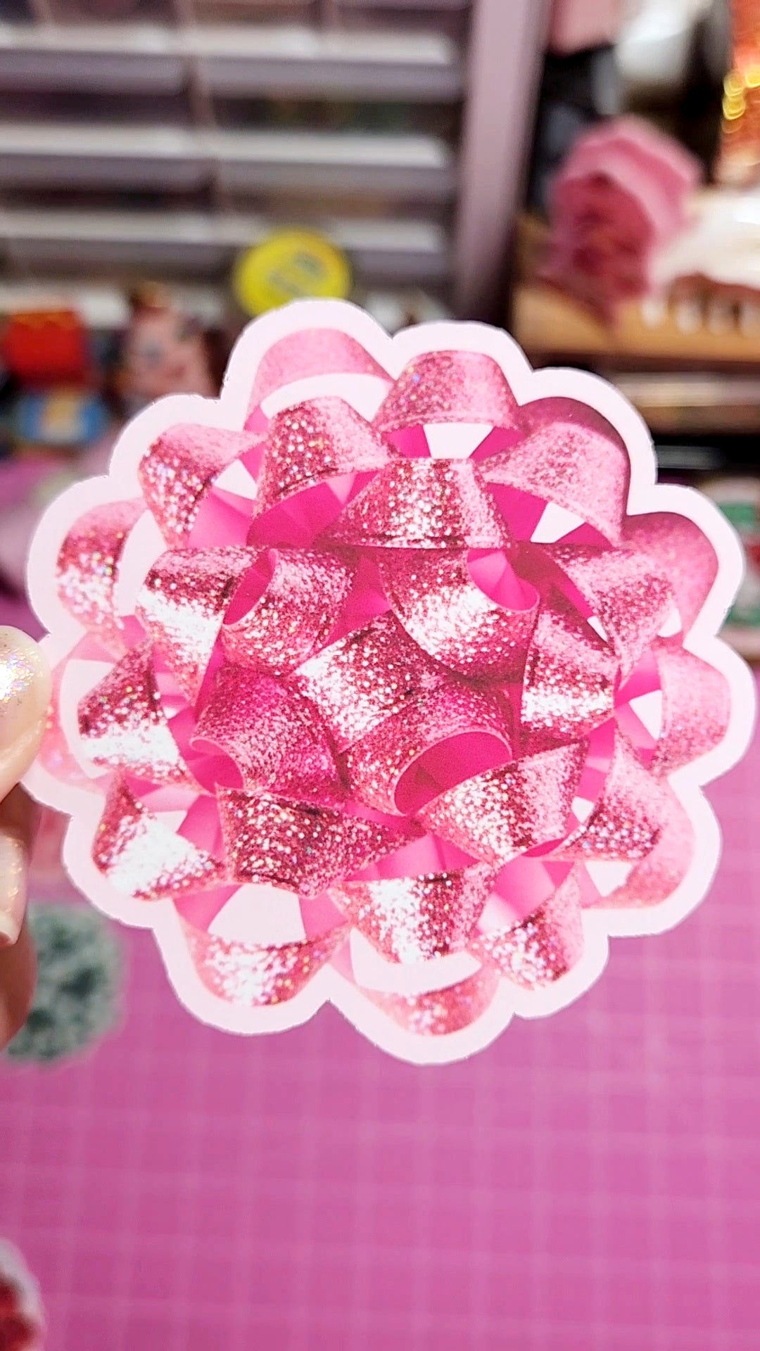 Decorative pink and silver flower-shaped object on a pink background