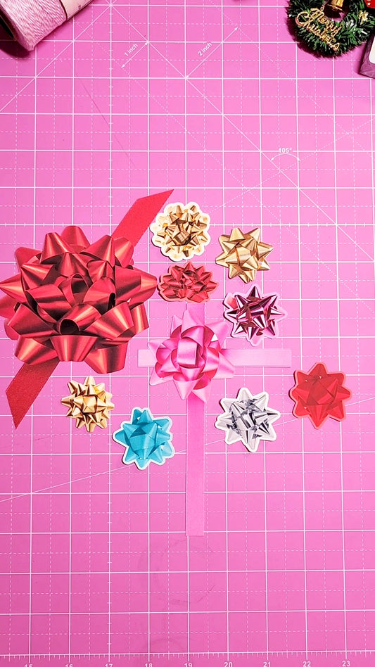 Colorful paper bows on a pink cutting mat with grid lines