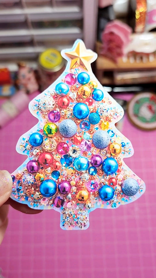 Decorative Christmas tree-shaped ornament with colorful beads on a pink background