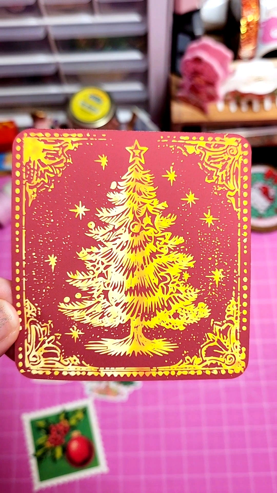 Card with a Christmas tree design on a red background