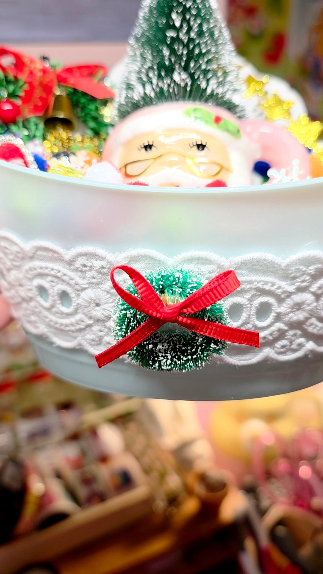 Decorative Christmas scene with a Santa Claus figurine in a bowl.