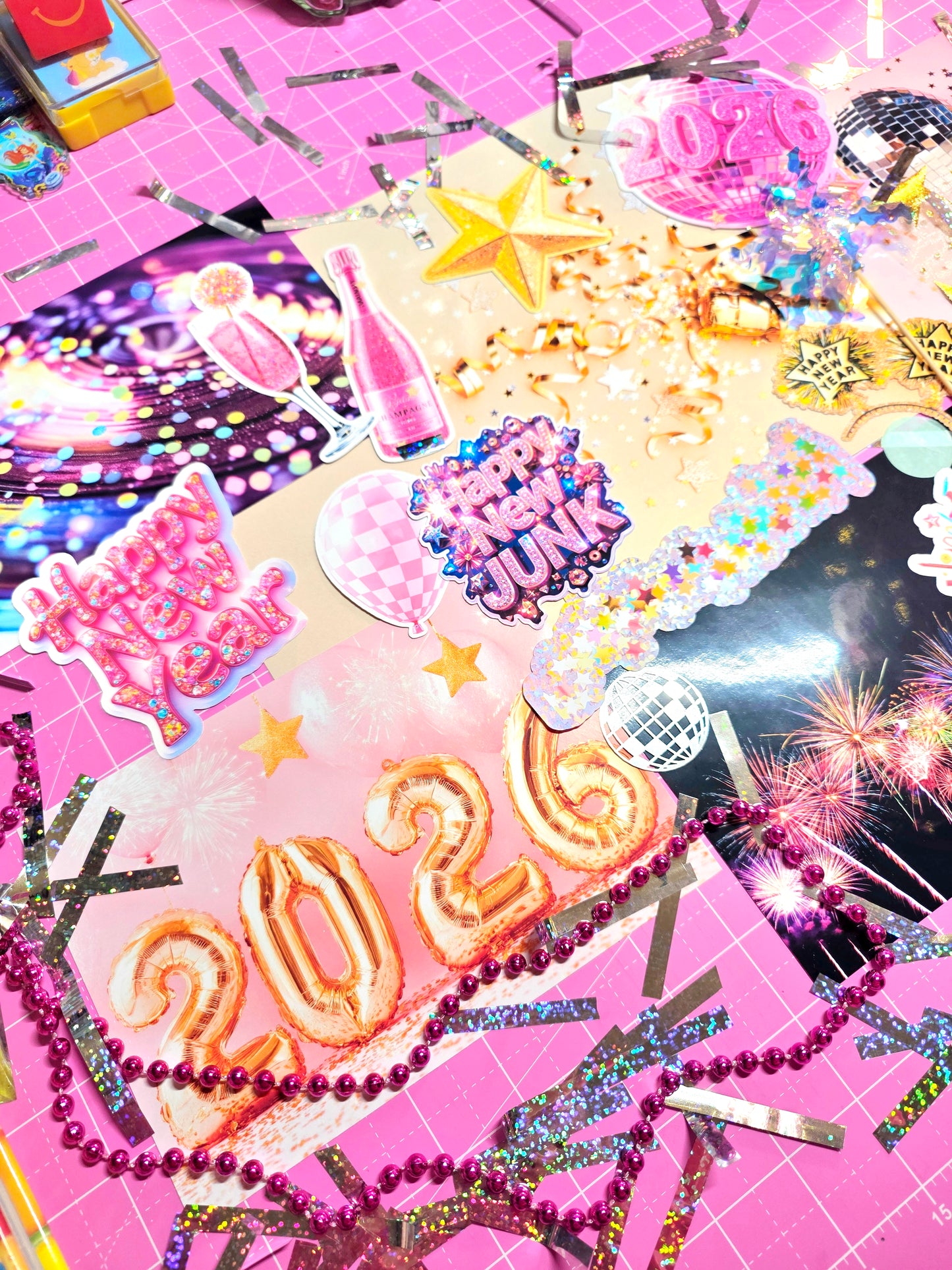 Colorful 2021 New Year's Eve decorations on a pink background