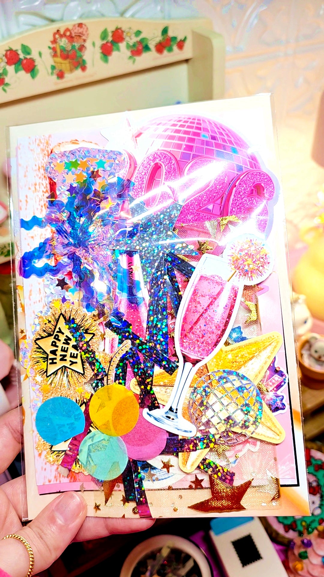 Colorful greeting card with festive design held by a hand