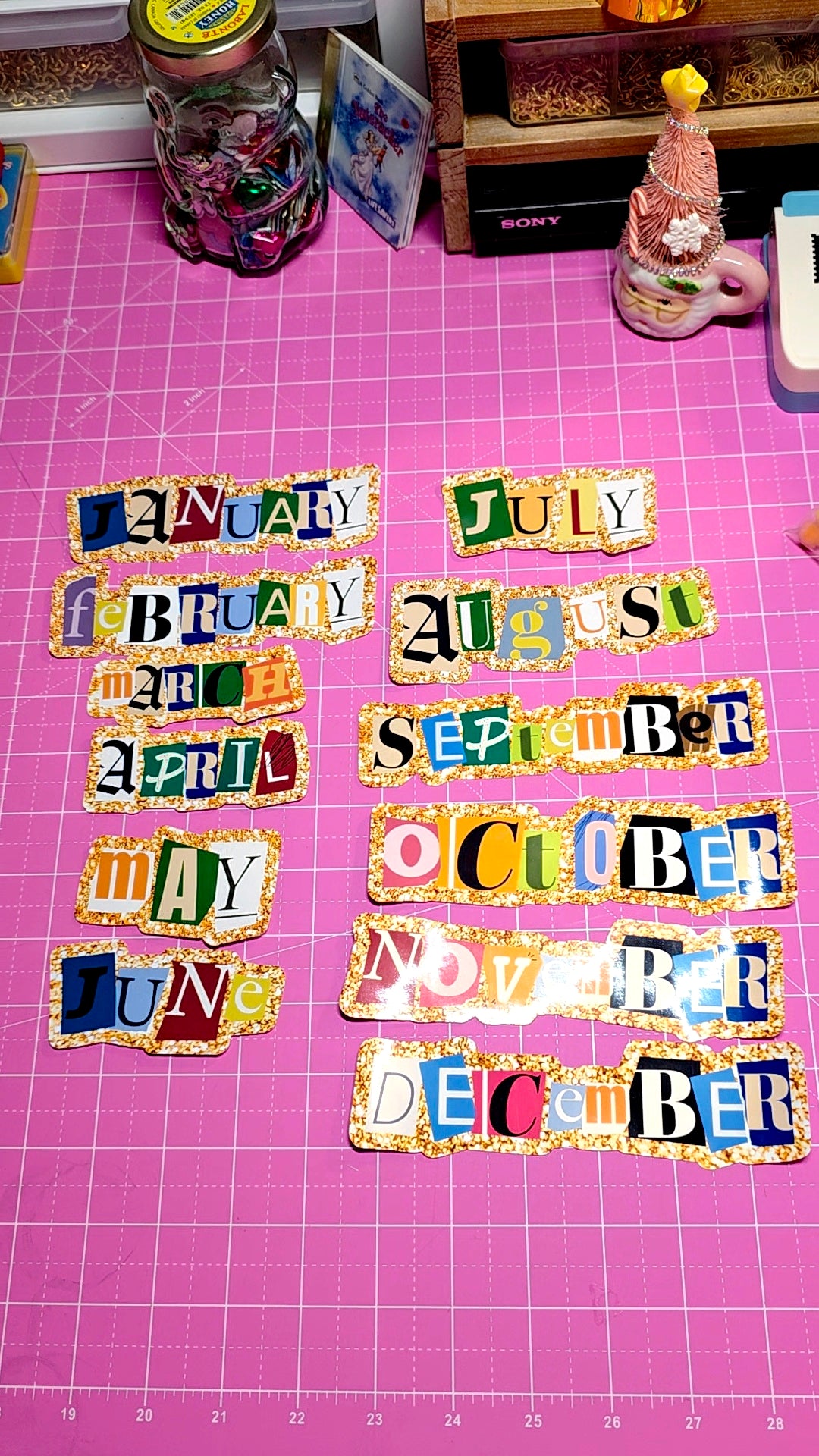 Colorful month names on a pink grid background