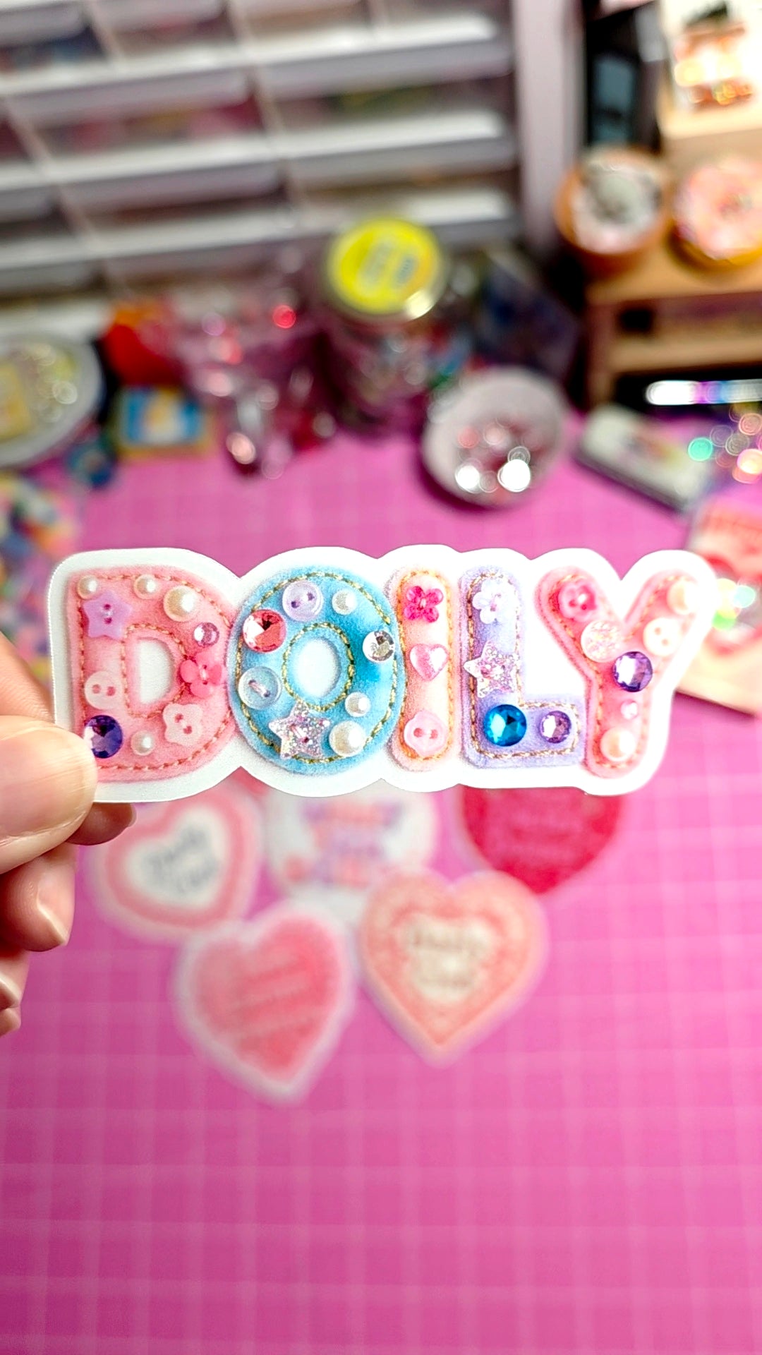 Decorative name badge with 'Dolly' on a pink background