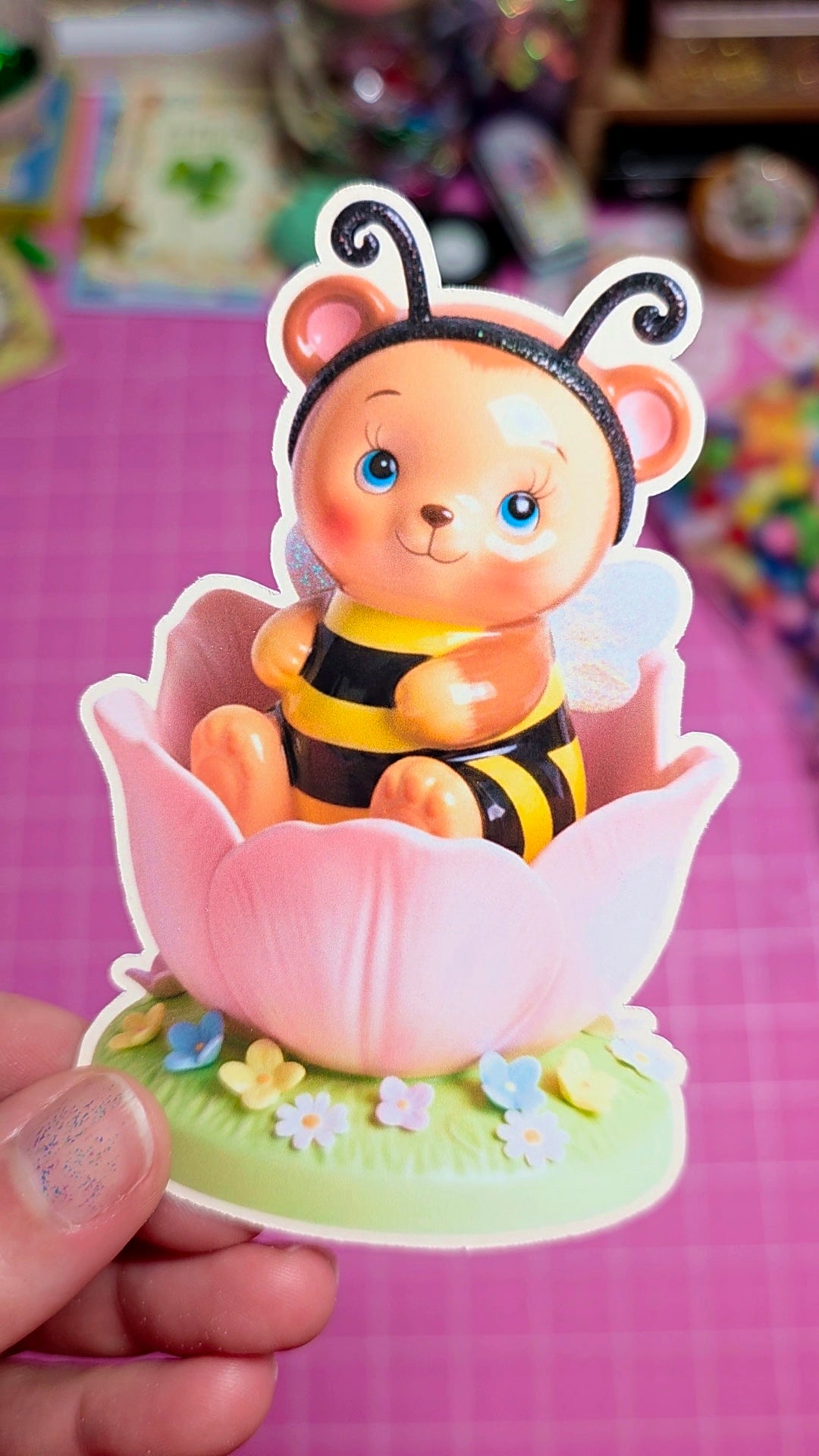 Cartoon bee character in a pink flower with a blurred background