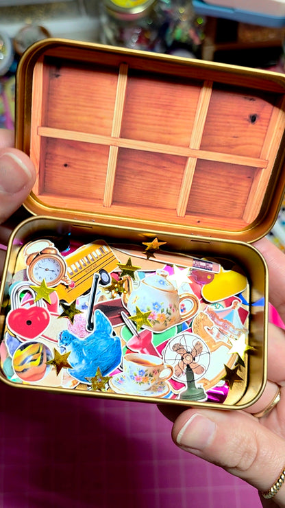 Colorful stickers inside a wooden box held by a person