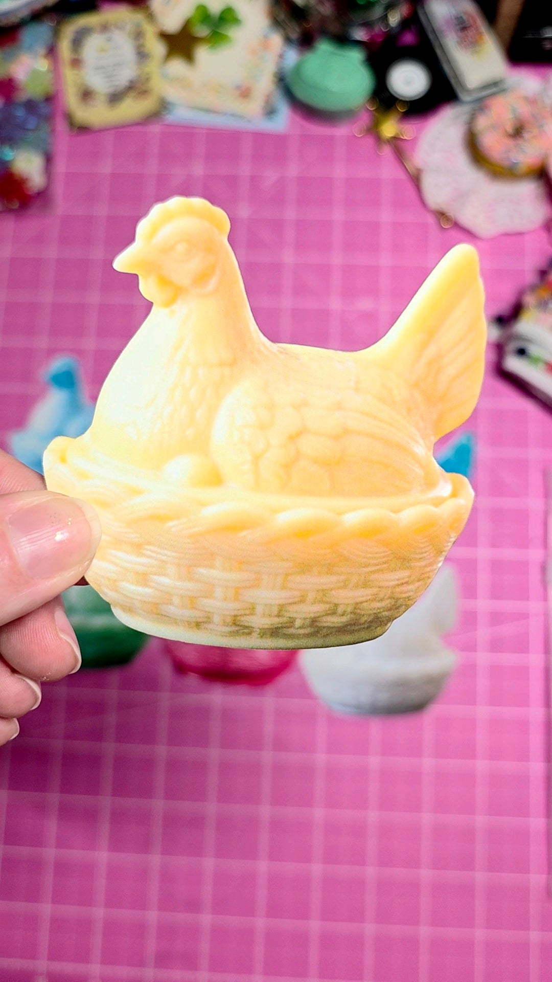 Candle shaped like a chicken on a pink checkered background