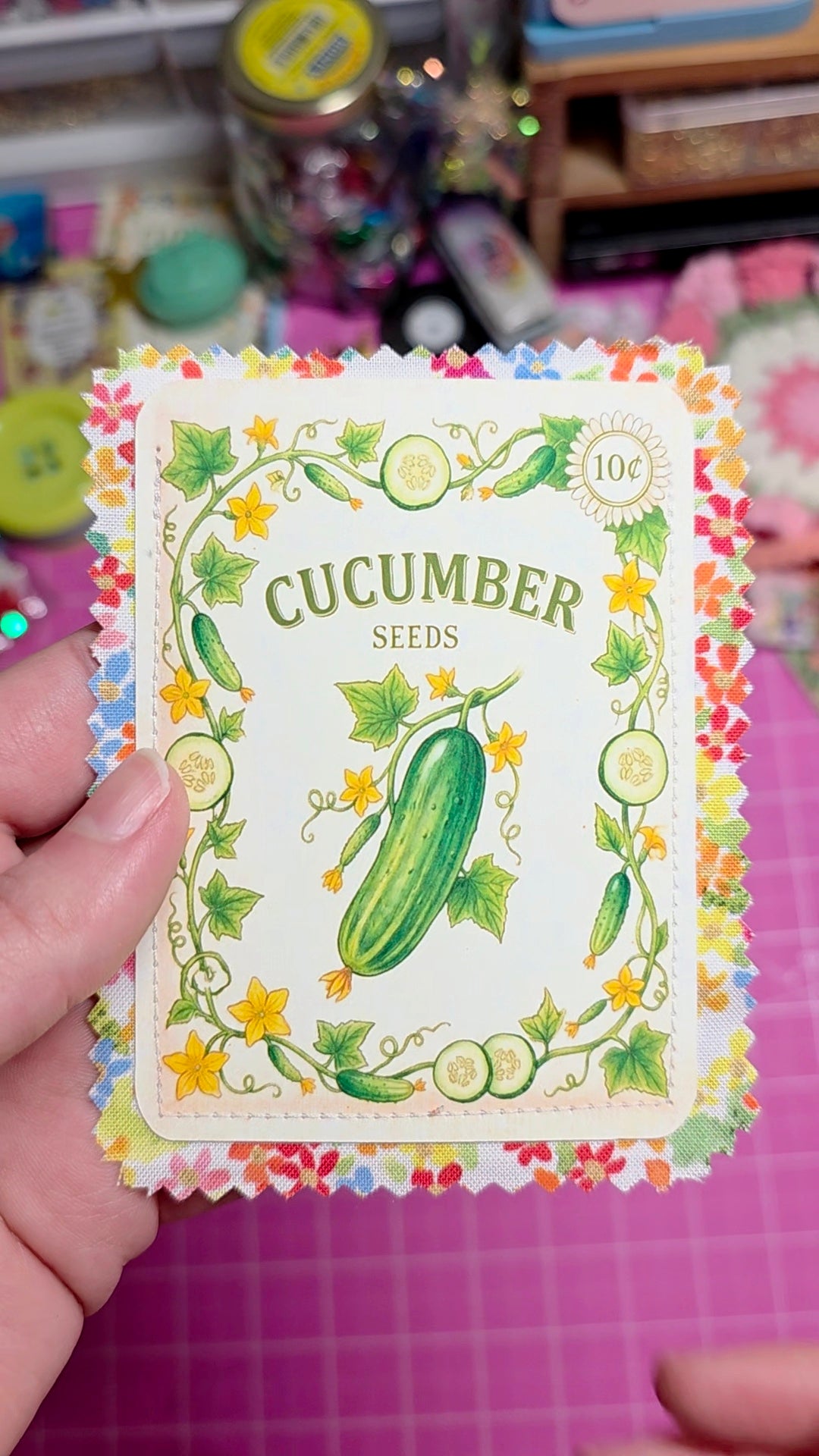 Card with cucumber seeds packaging featuring a colorful border and illustration of a cucumber.