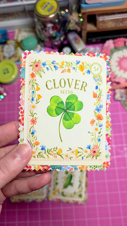 Card with a four-leaf clover design and text on a pink grid background