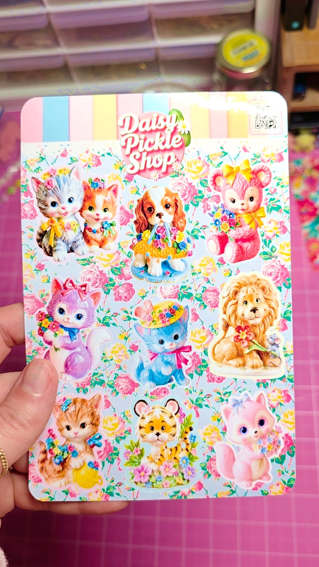 Sticker book with colorful animal illustrations on a pink background