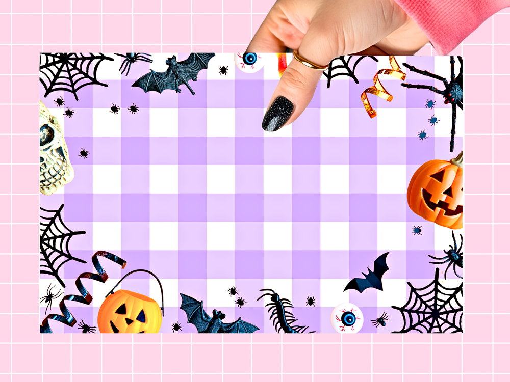 A square Halloween-themed decorative print or card with a lavender and white gingham center, surrounded by spooky illustrations including bats, spiders, cobwebs, pumpkins, skulls, and eyeballs. A hand with black glitter nail polish is holding the top edge, against a pink grid background.