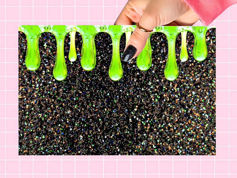 A rectangular black glitter mat with bright green slime dripping along the top edge, held by a hand with black glitter nail polish against a pink grid background.