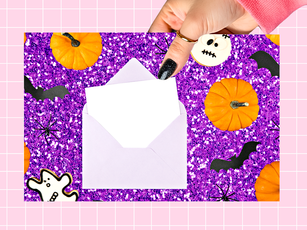 A hand with black glitter nail polish holds a white envelope over a purple glitter Halloween-themed card featuring orange pumpkins, black bats, white ghosts, and a jack-o'-lantern.