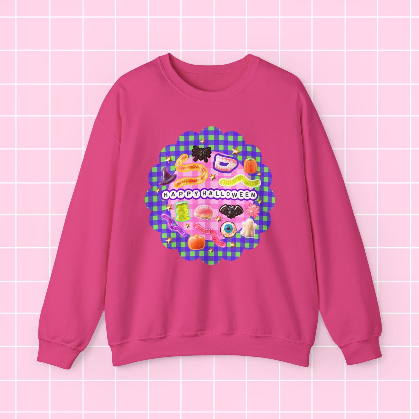 A pink crewneck sweatshirt featuring a colorful retro graphic with the text 'I DON'T LIKE APPETITES' on a pink and green gingham background, displayed on a light pink grid backdrop.