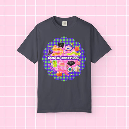 A dark charcoal gray t-shirt with a colorful 'Happy Halloween' graphic on the chest, displayed against a pink grid background.