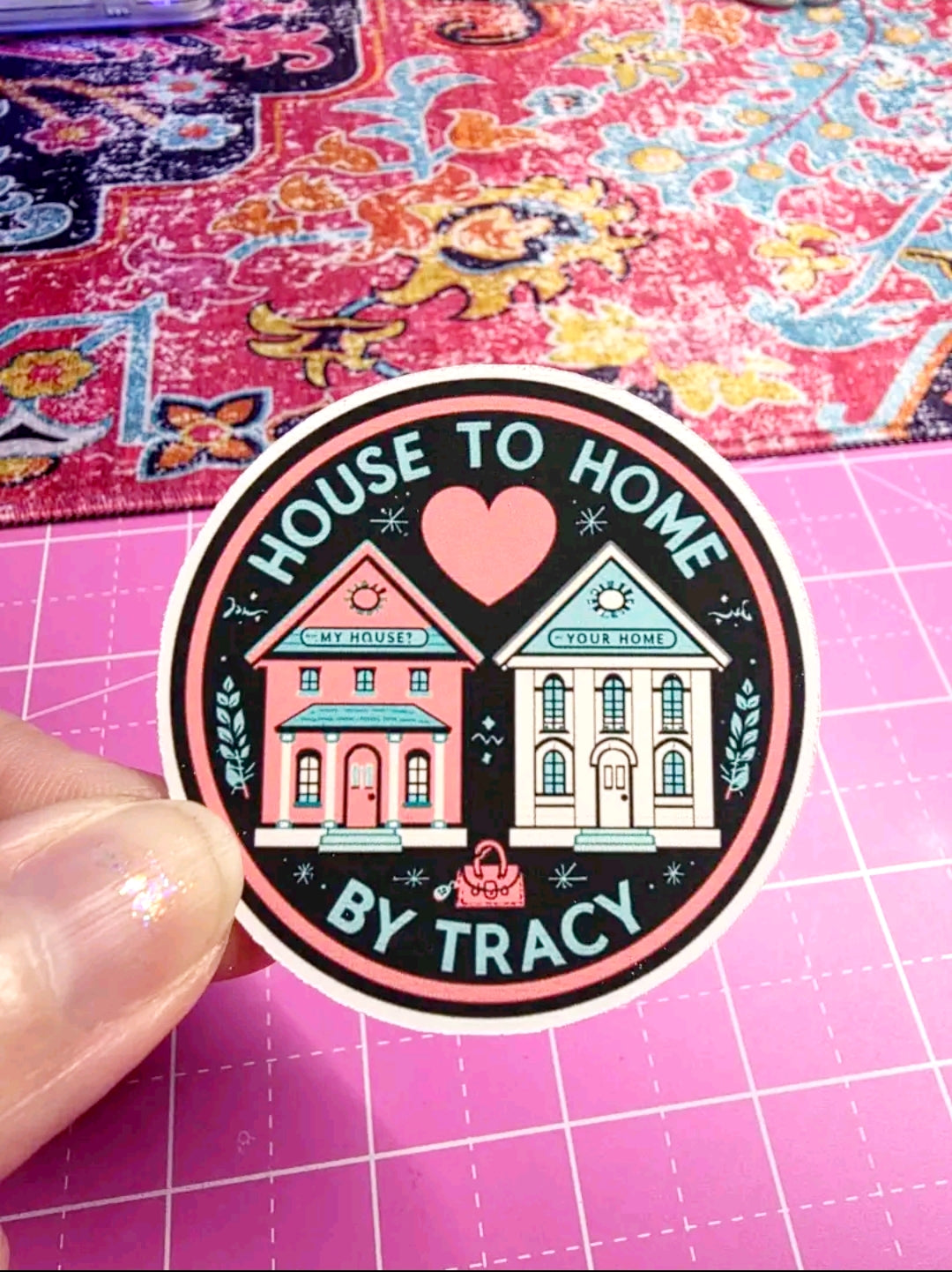 Sticker with 'House to Home by Tracy' design on a pink grid background