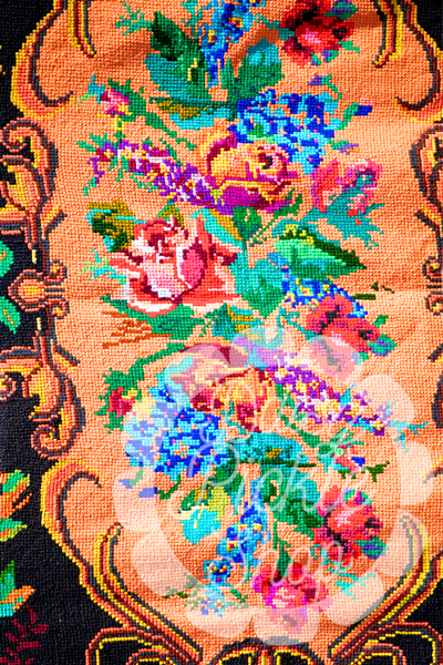 Close-up of a colorful floral pattern on fabric with intricate details.