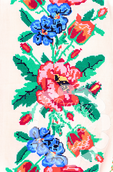 Close-up of a floral pattern with red, blue, and green flowers on a white background
