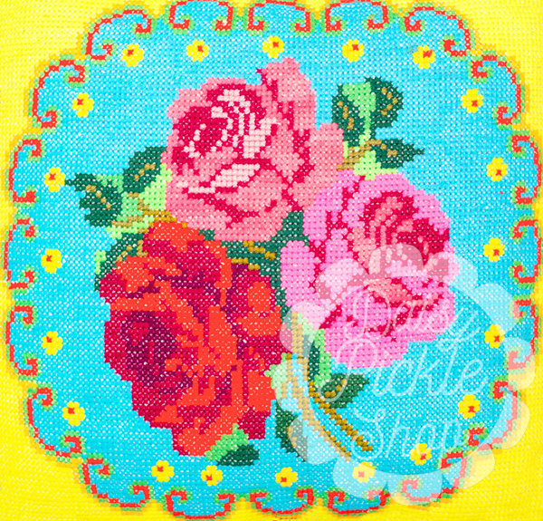 Colorful floral design with roses on a blue background, featuring the brand 'Sukie Sues'.
