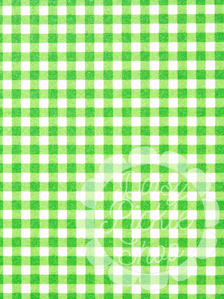 Green and white checkered pattern with a transparent circular object overlay.