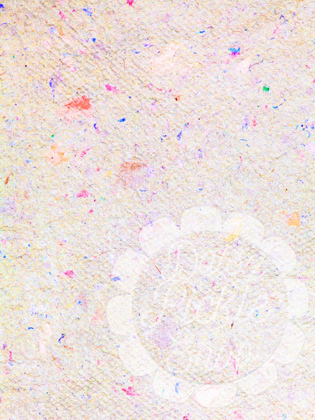 Close-up of a textured fabric with colorful specks on a beige background