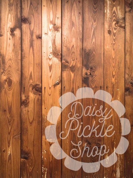 Wooden panel with 'Daisy Pickle Shop' logo