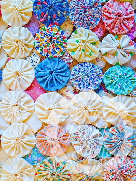 Colorful meringue cookies with various patterns on a textured surface