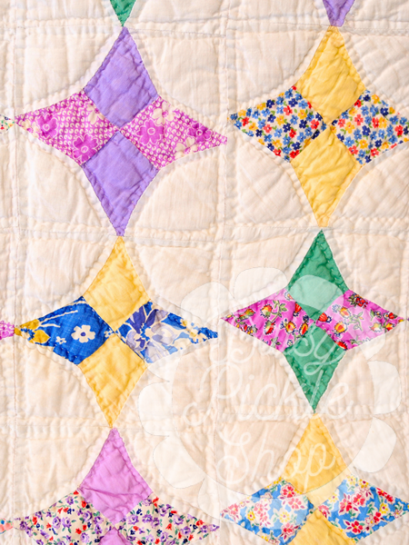 Colorful quilt with diamond pattern on a white background