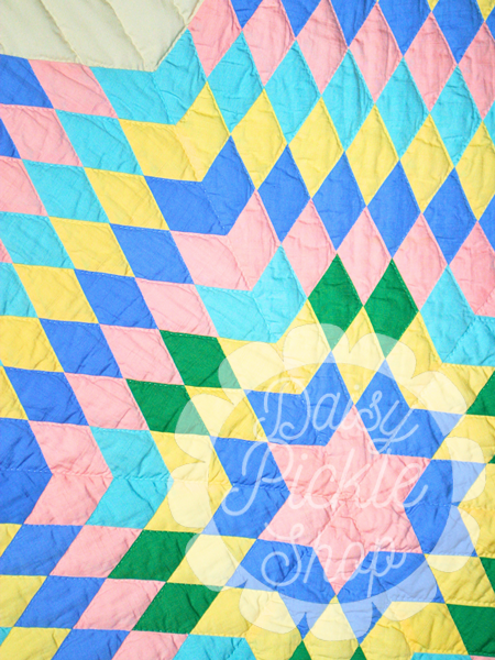 Colorful quilt with geometric pattern and 'Jazzy' branding