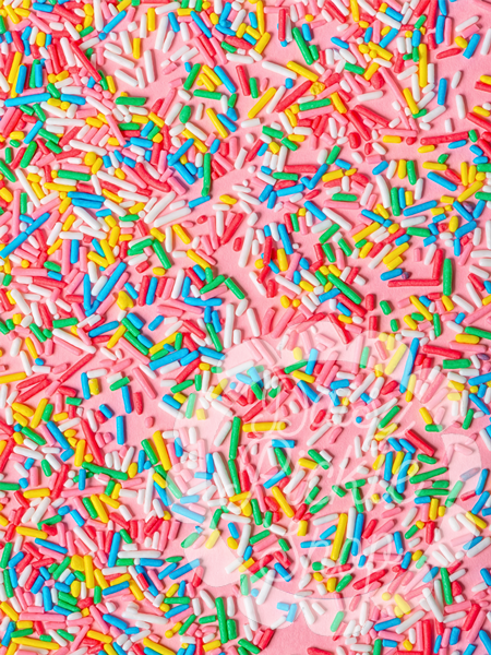 Colorful sprinkles on a pink background