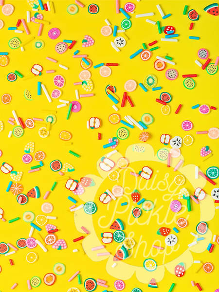 Colorful candy pattern on a yellow background with 'Tuck Shop' text.