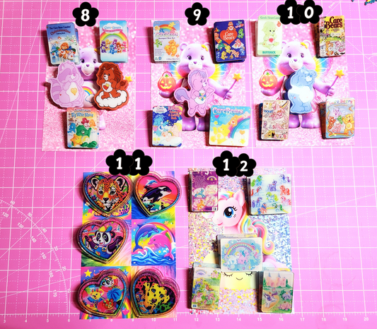 Collection of colorful toys and books on a pink grid background