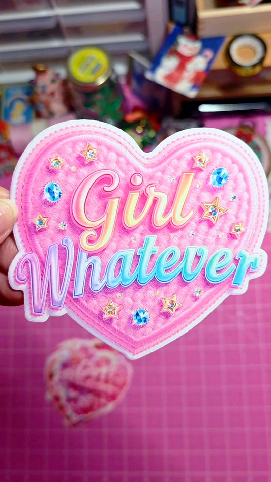 Heart-shaped pink patch with 'Girl Whatever' text on a pink background