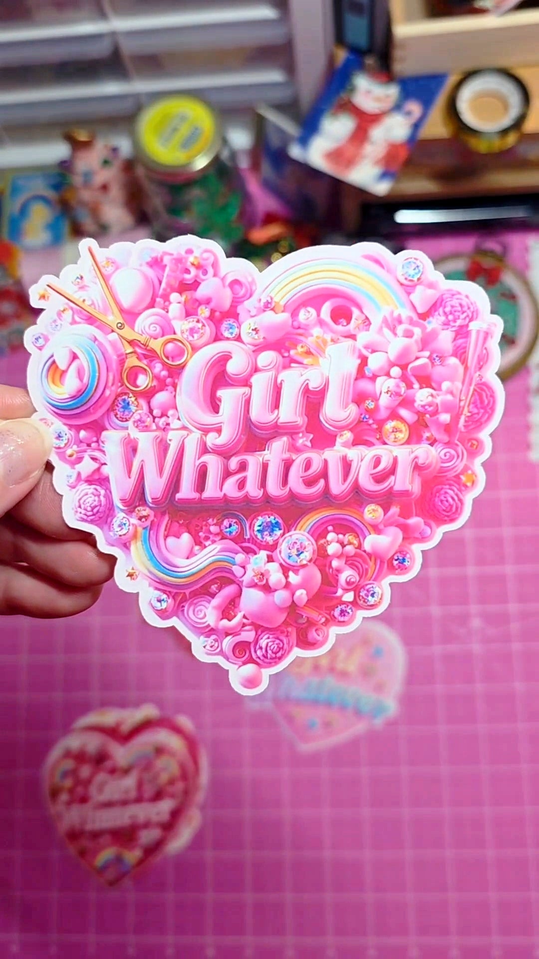 Heart-shaped sticker with 'Girl Whatever' text on a pink background