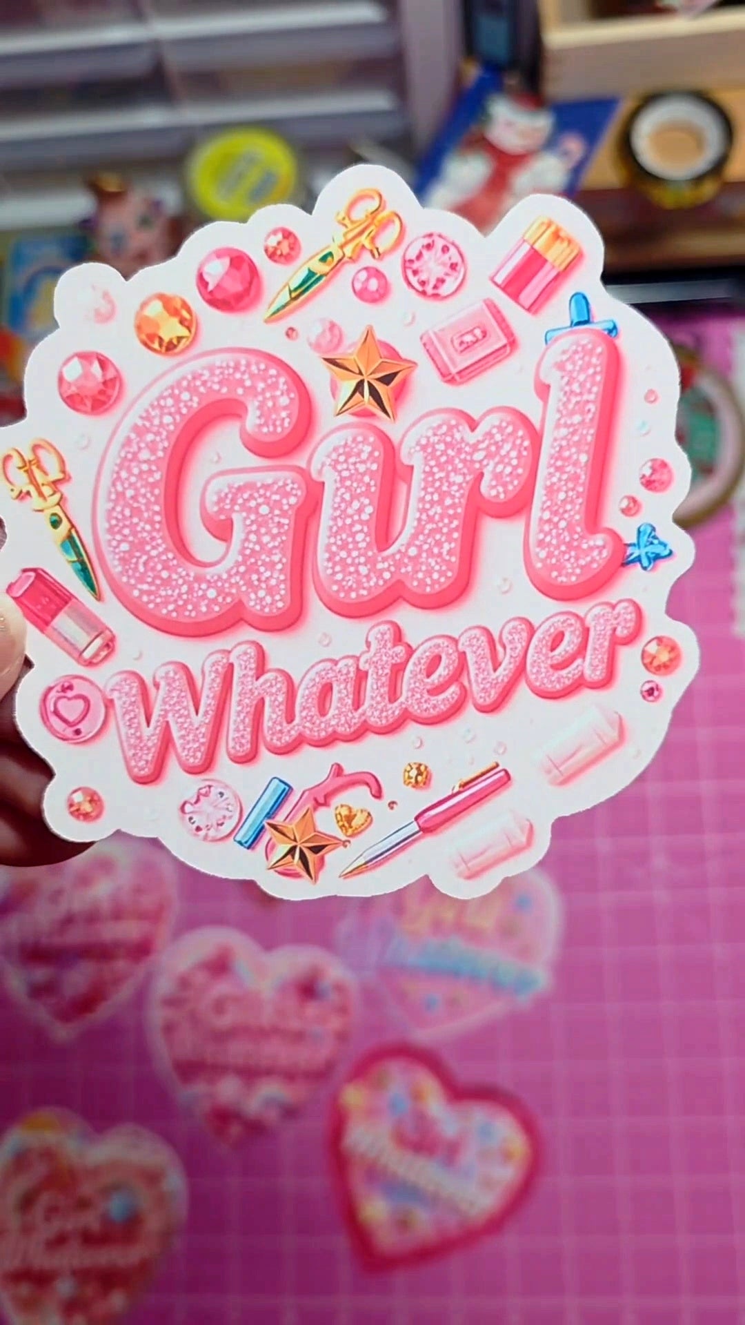 Decorative sticker with 'Girl Whatever' text on a pink background